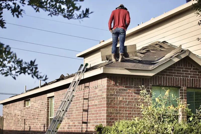 Professional roofer working on a residential roof in Delaplane